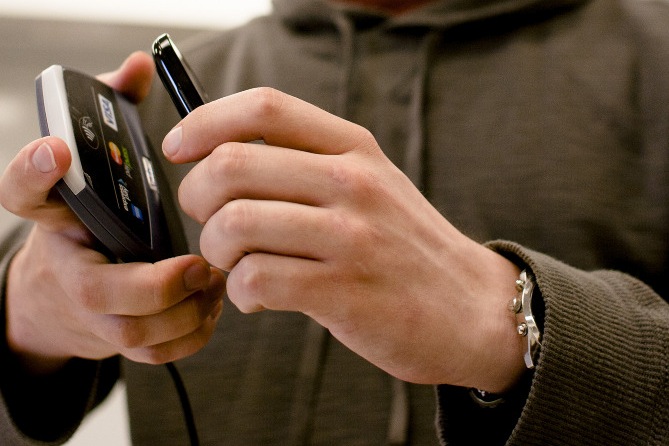Picture of user demonstrating alignment of NFC sensors