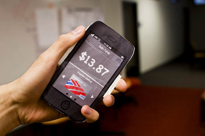 Photo of lo-fidelity physical prototype of a phone with an app screen made from paper