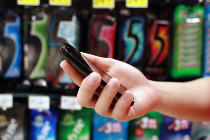 Side view of hand holding phone
