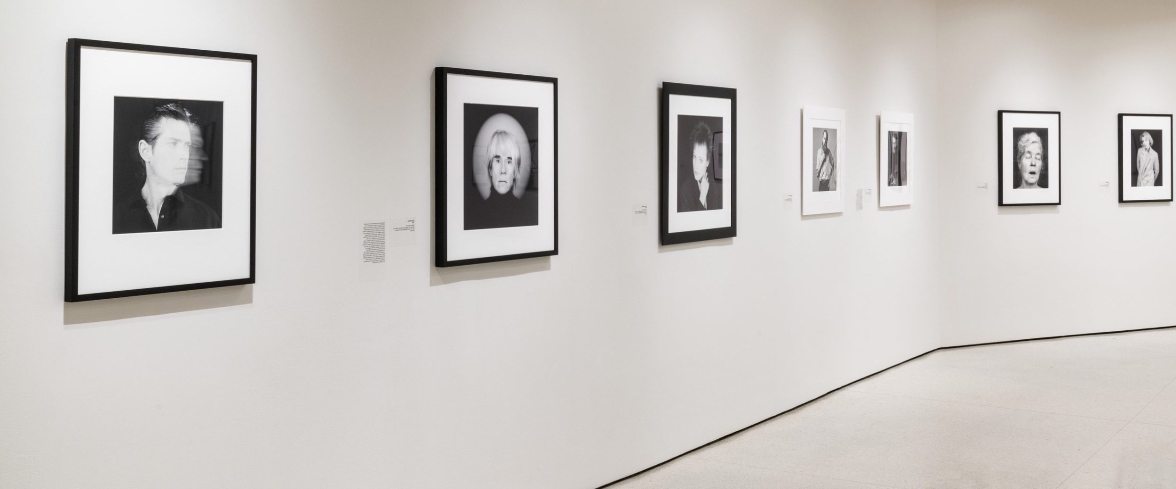 Photo showing array of portraits in physical context, on a path